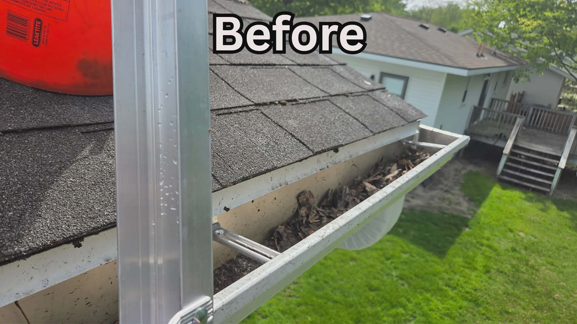 Clogged gutters filled with leaves and debris before gutter cleaning in Muskegon MI